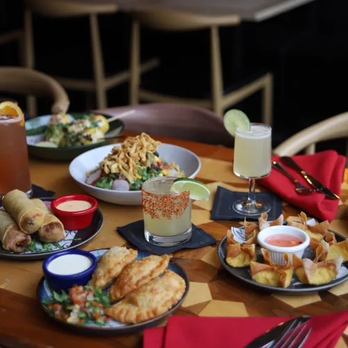 Full MuNi KC table spread of appetizers and cocktails in the dining room