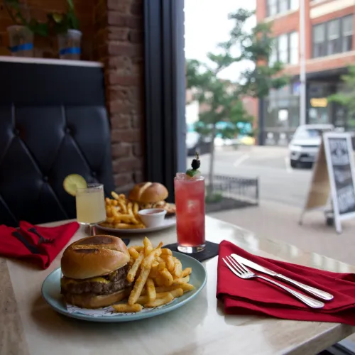 MuNi KC cheeseburger and fries on a window table overlooking the downtown street