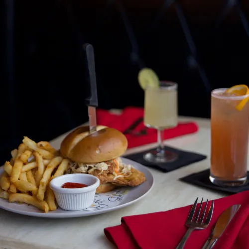 MuNi KC fried chicken sandwich with fries and two cocktails